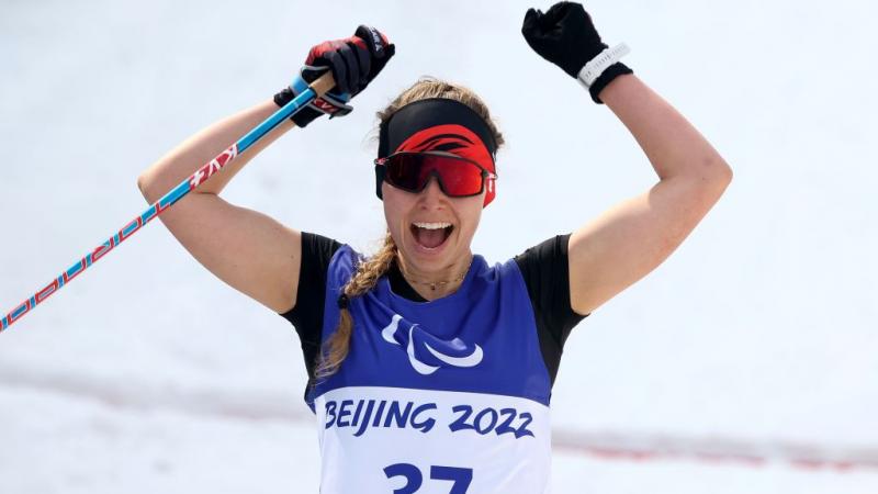 Canada's Natalie Wilkie celebrates her gold in the Women's Sprint Free Technique Standing in the Beijing 2022 Paralympic Winter Games at Zhangjiakou National Biathlon Centre.