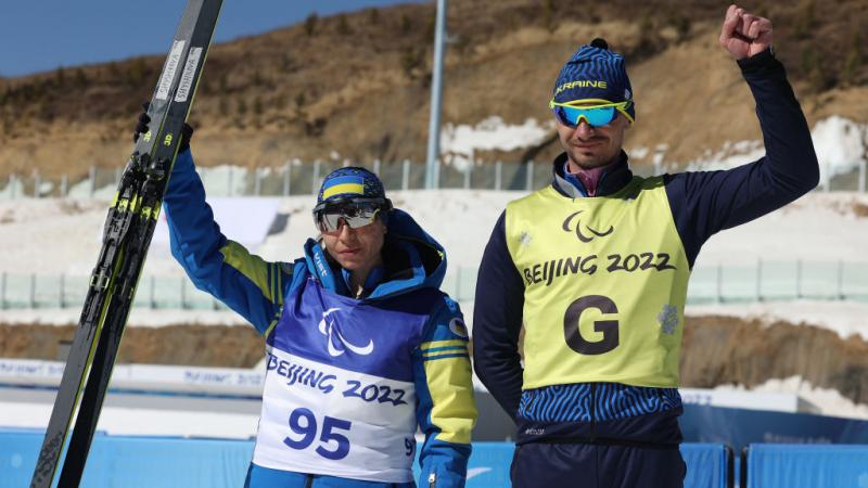 IN THE FORM OF HER LIFE: Gold medallist Oksana Shyshkova of Ukraine (left) with guide Andriy Marchenko celebrates after winning  the Para Cross-Country Skiing Women's Long Distance Classical Technique Vision Impaired at the Beijing 2022 Winter Paralympics.