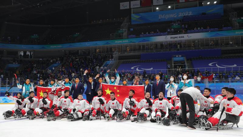 Group photo of Para ice hockey players and staff celebrating the win.