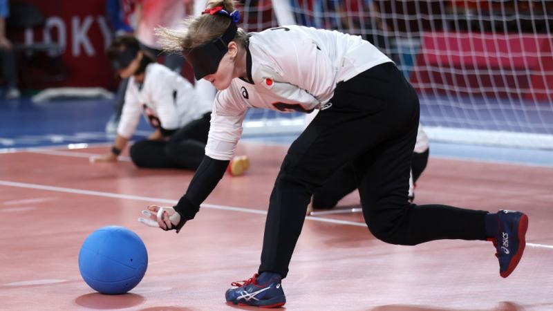 Japan's Eiko Kakehata releases the ball to the ground, fingers outstretched, as she shoots during her team's semifinal match against Team Brazil at the Tokyo 2020 Paralympic Games.