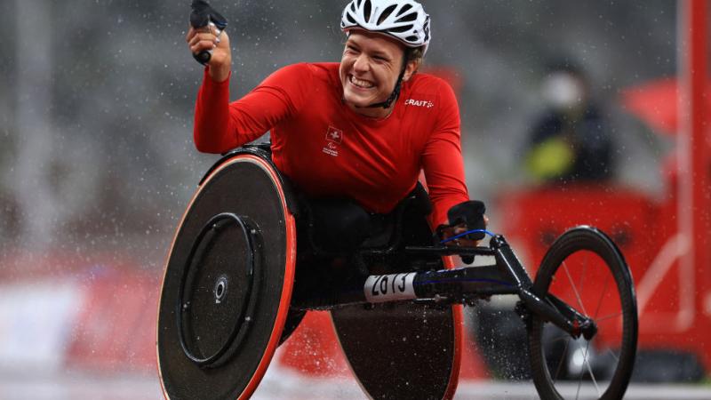 Image of a female Para Athletics athletes happy after she crosses the finish