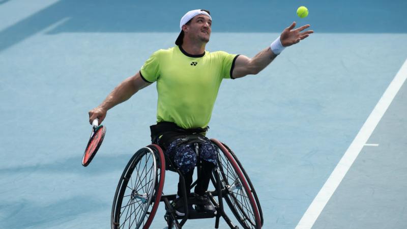 Argentina's Gustavo Fernandez serves in a doubles match at the 2022 Australian Open.