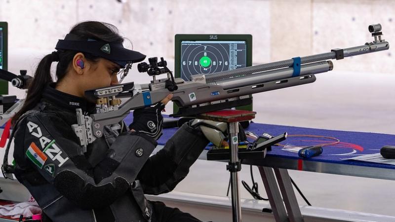 A female shooter with a rifle in a shooting Para sport competition