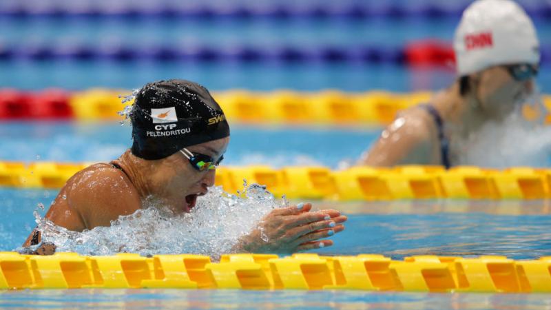 Two women swimming breaststroke in a pool