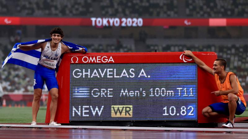 Image of a male Para Athletics and his guide near to their time on the track