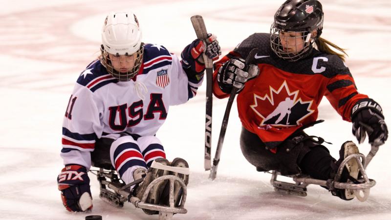 Image of two female Para ice Hockey players on the ice
