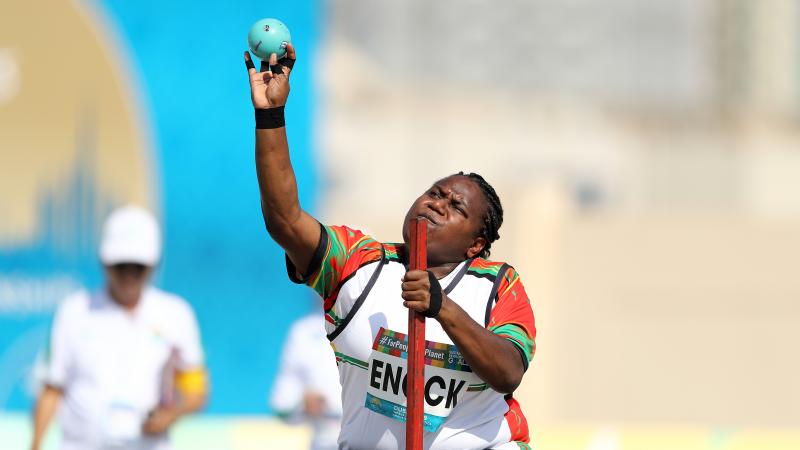 A woman about to make a throw in a seated shot put competition.