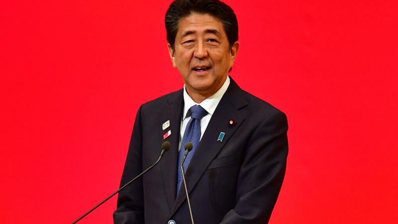 Photo of Japanese male Prime Minister speaking on podium