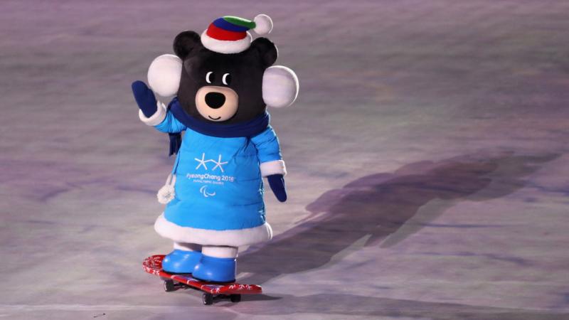 A PyeongChang 2018 mascot rides a skateboard and waves during the Games Opening Ceremony.