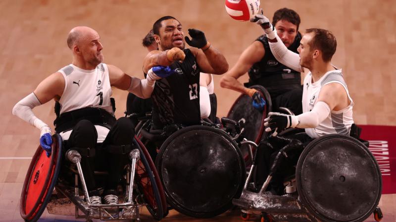 Five players from the Denmark and New Zealand teams battle for the ball.