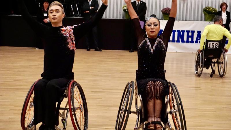 A male and a female wheelchair dancers side by side in a presentation