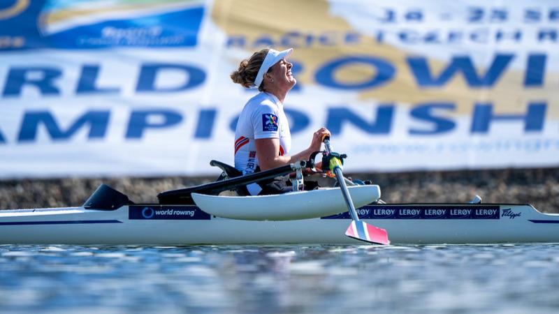 A side view of a female athlete on a rowing boat.