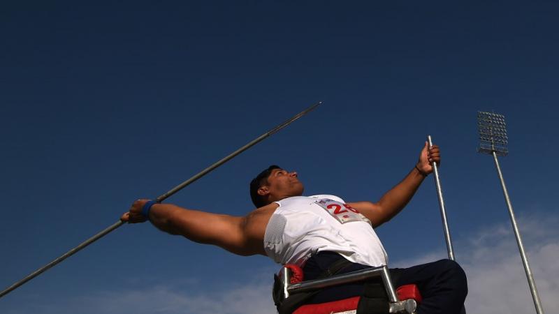 A male athlete in a chair competing in javelin throw