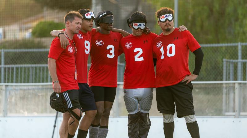 Five male athletes wearing a red T-shirt 