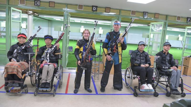 Medallists strike a pose after the end of the R10 - 10m air rifle standing mixed team SH1 finals at the Al Ain Equestrian, Shooting and Golf Club.