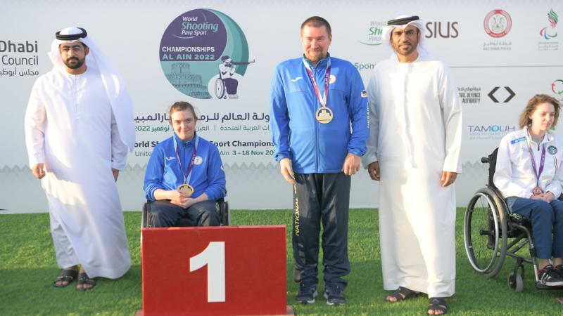 Ukraine's Vasyl Kovalchuk and Anastasiia Telizhenko pose with their gold medals at Al Ain 2022.