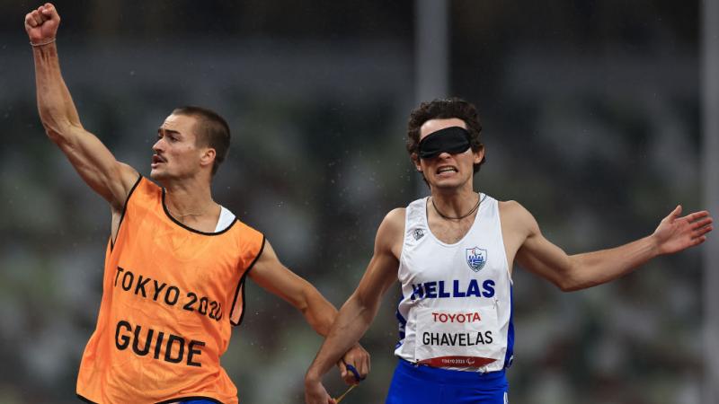 Greece's Athanasios Ghavelas celebrates with his guide Sotirios Gkaragkanis after winning gold in the men’s 100m T11 at the Tokyo 2020 Paralympic Games. 