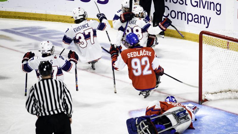 Four US Para ice hockey players celebrating against Czechia 