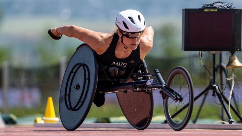 A female wheelchair racer on a red athletics track