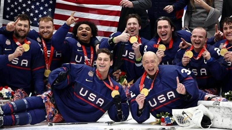 The USA Para ice hockey national team celebrating on ice