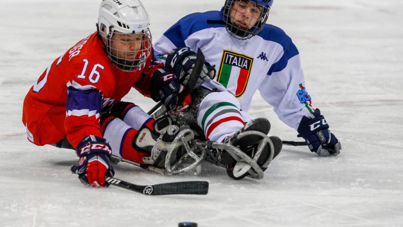 Two male Para ice hockey players competing on ice
