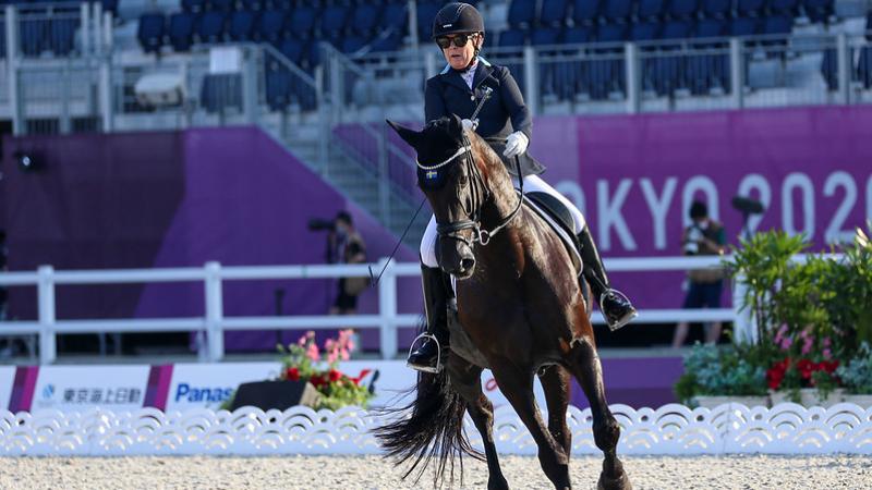 A female athlete rides a horse at Tokyo 2020