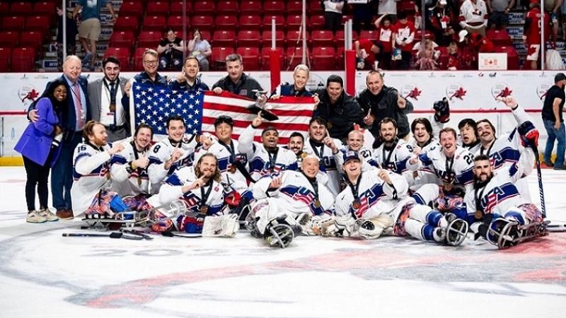 The USA Para ice hockey national team celebrating on ice at the Moose Jaw 2023 World Championships