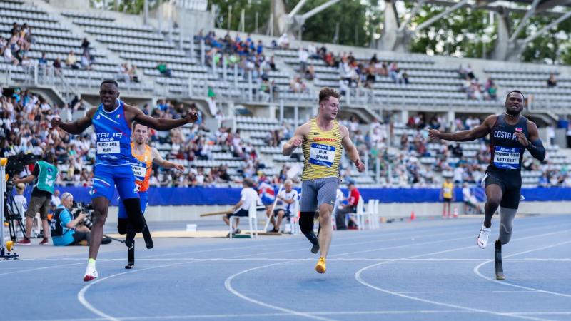 Three male blade runners in a Para athletics race