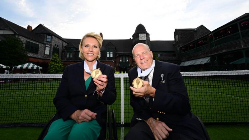 Esther Vergeer Rick Draney holding up their medals and smiling 