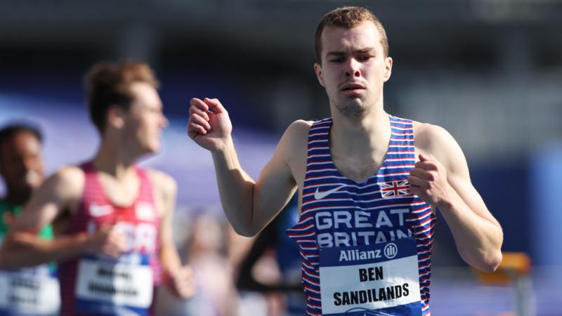 A male runner ahead of other runners in a competition