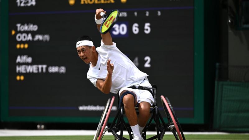 A male wheelchair tennis player competes