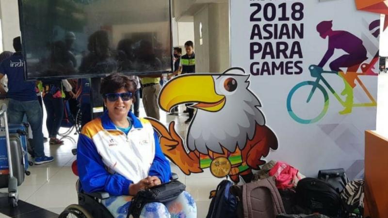 Woman in a wheelchair at an aiport lobby