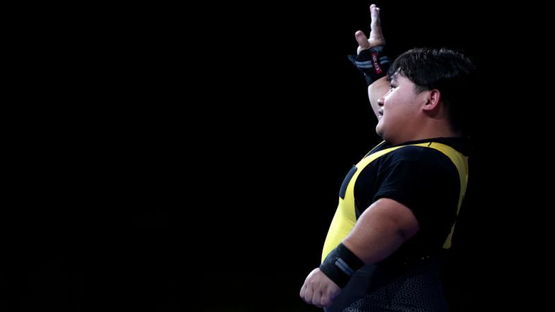 A male powerlifter waving 