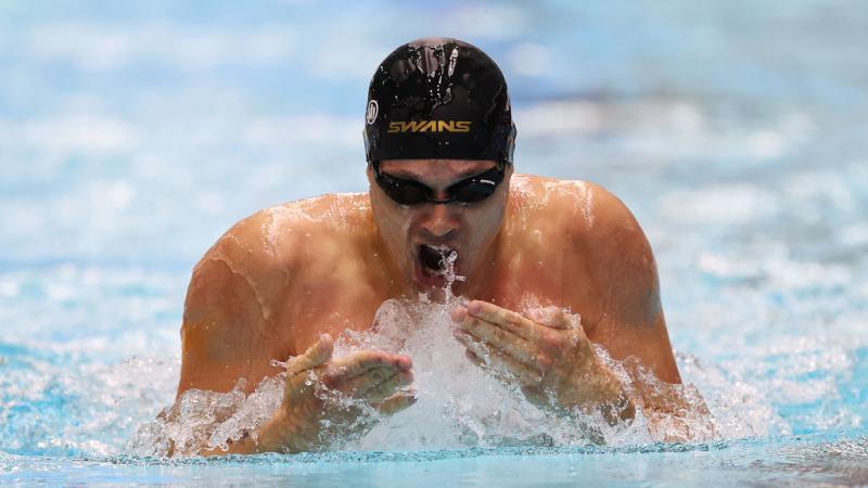 A male athlete swimming breaststroke