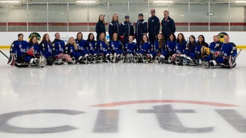 The USA women's Para ice hockey national team in a team picture on an ice rink