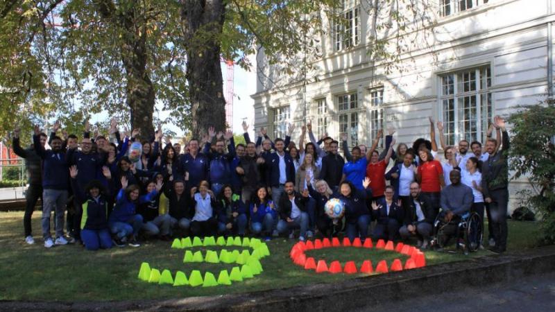 IPC staff in Bonn gathers infront of headquarter building with number 30 marked on lawn