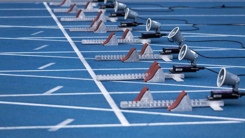 The starting blocks on a blue athletics track