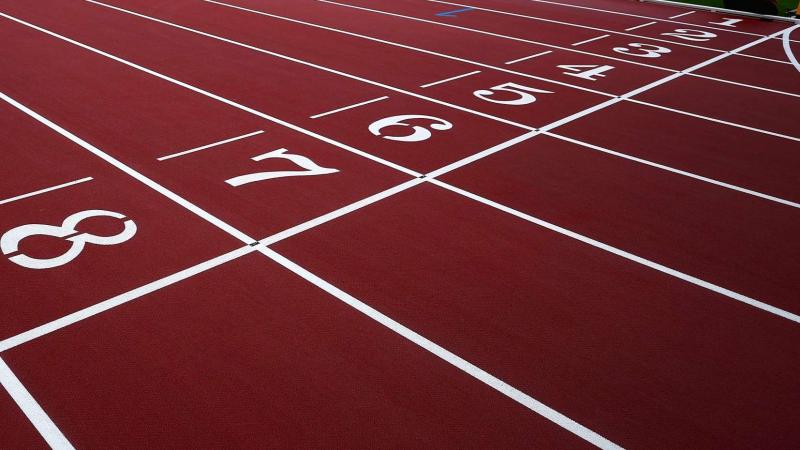 The finish line of a red athletics track