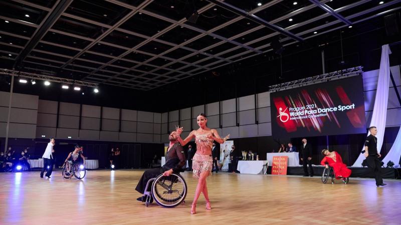 A female standing dancer and a male wheelchair dancer in a competition
