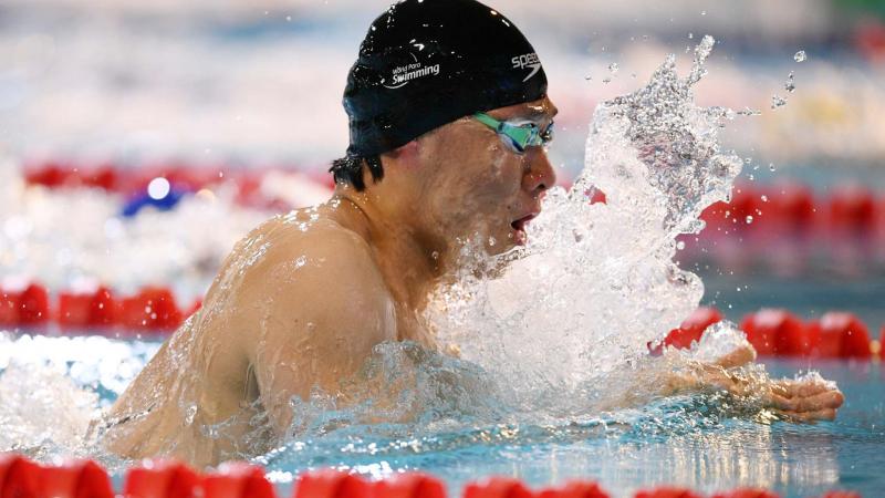 A male swimmer in a breaststroke race