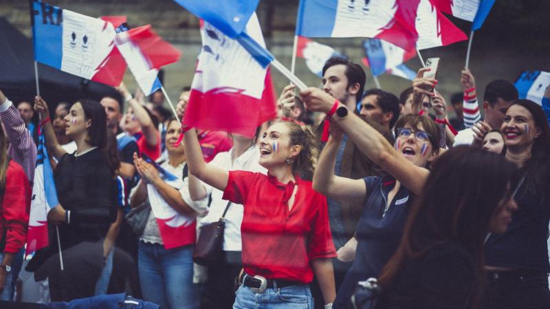 French fans waving flags in Paris.