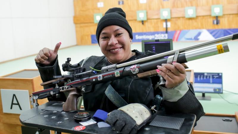 A female Para athlete with a rifle in a shooting range