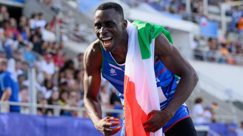 A male athlete celebrates after a win.