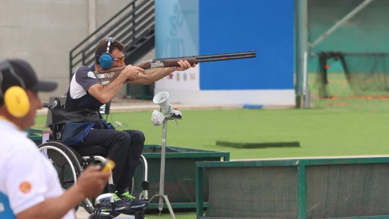 A man in a wheelchair competing in a Para trap event