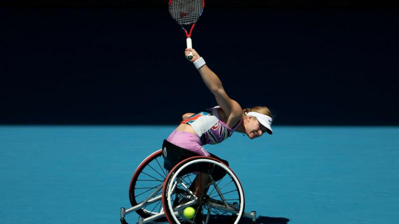 A female athlete plays a backhand in the women's singles final at the Australian Open.