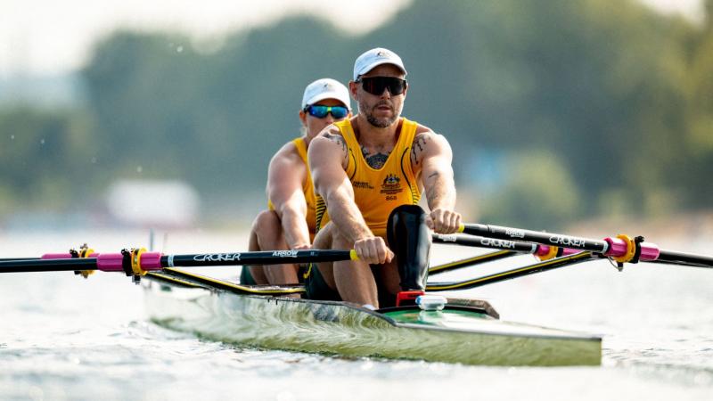 Two Para rowers - a male athlete and a female athlete - compete.