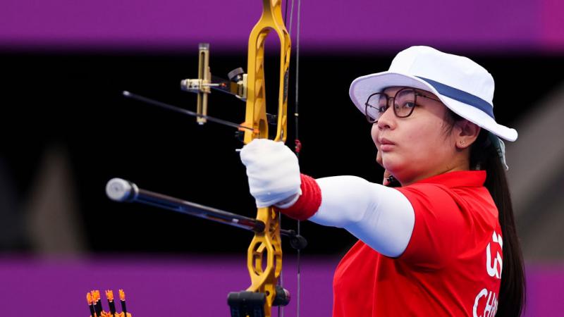 Para archer Chen Minyi aims her bow and arrow ready to shoot 