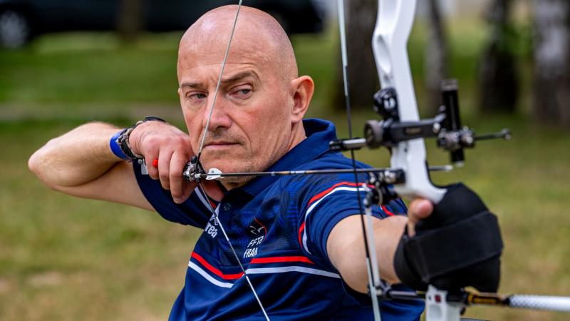 A male Para archer aims at a target