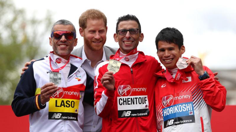 El Amin Chentouf smiles with his gold medal alongside other athletes and Prince Harry