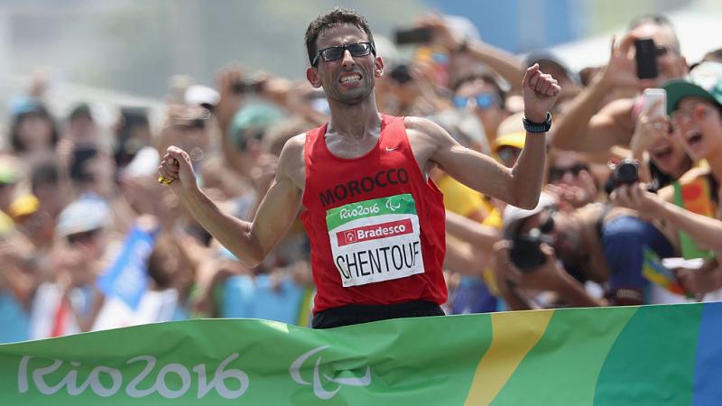 El Amin Chentouf celebrates breaking the tape at the Rio 2016 finish line 